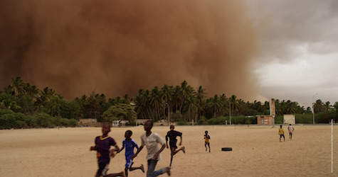 children running with a sandstorm beginning